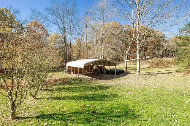 a swimming pool with trees in front of it
