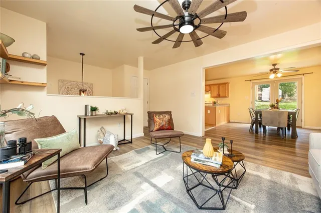 a living room with lots of furniture and a chandelier