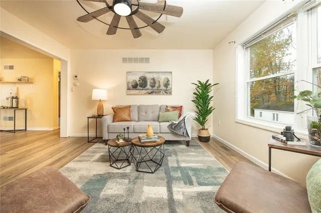 a living room with furniture and a large window