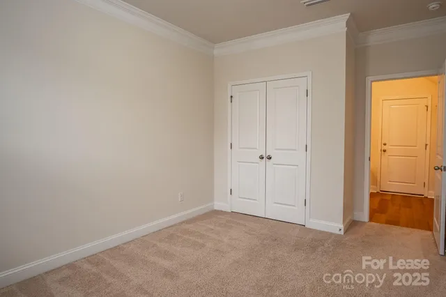 a bathroom with a granite countertop toilet sink and mirror