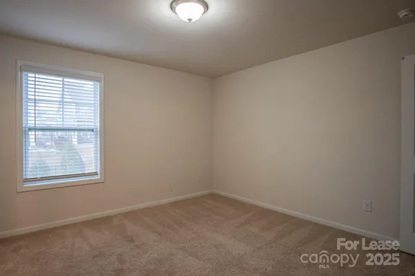 a view of an empty room and a window