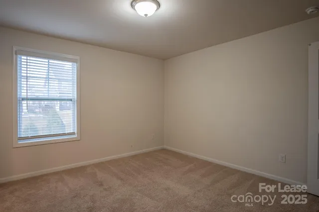 a view of an empty room and a window