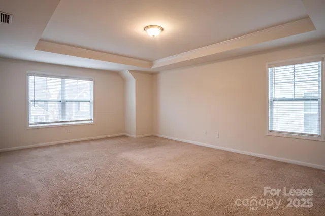 an empty room with a window and a fireplace