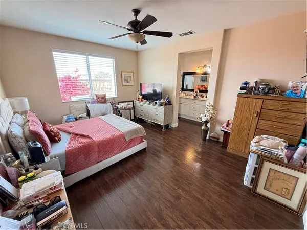 a bedroom with a bed a couch and a window