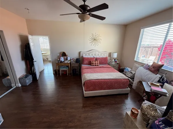 a bedroom with a bed furniture and a flat screen tv
