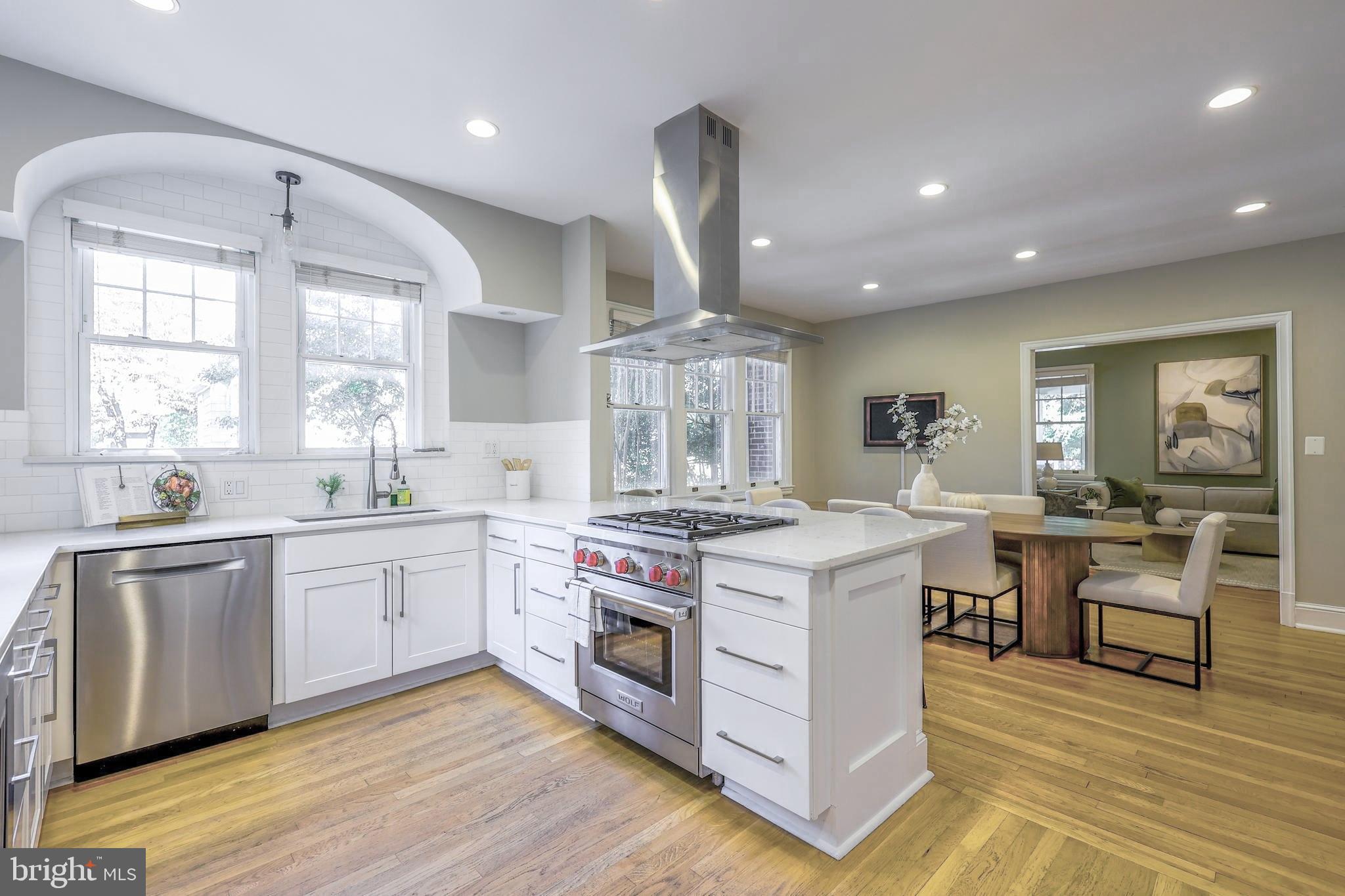 3230 Military Road Northwest Washington, DC 20015 - Photo 16 of 61 a large kitchen with stainless steel appliances granite countertop a stove oven and white cabinets