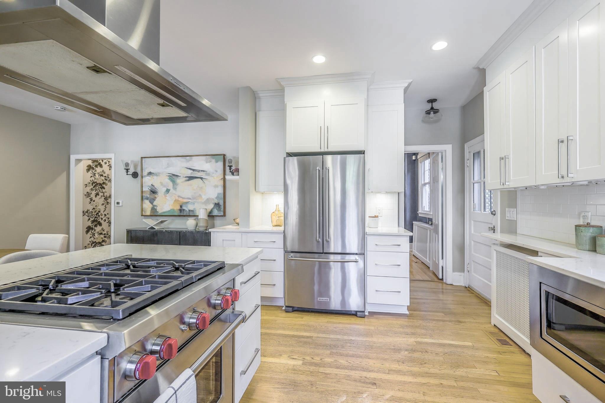3230 Military Road Northwest Washington, DC 20015 - Photo 19 of 61 a kitchen with stainless steel appliances granite countertop a stove and a refrigerator