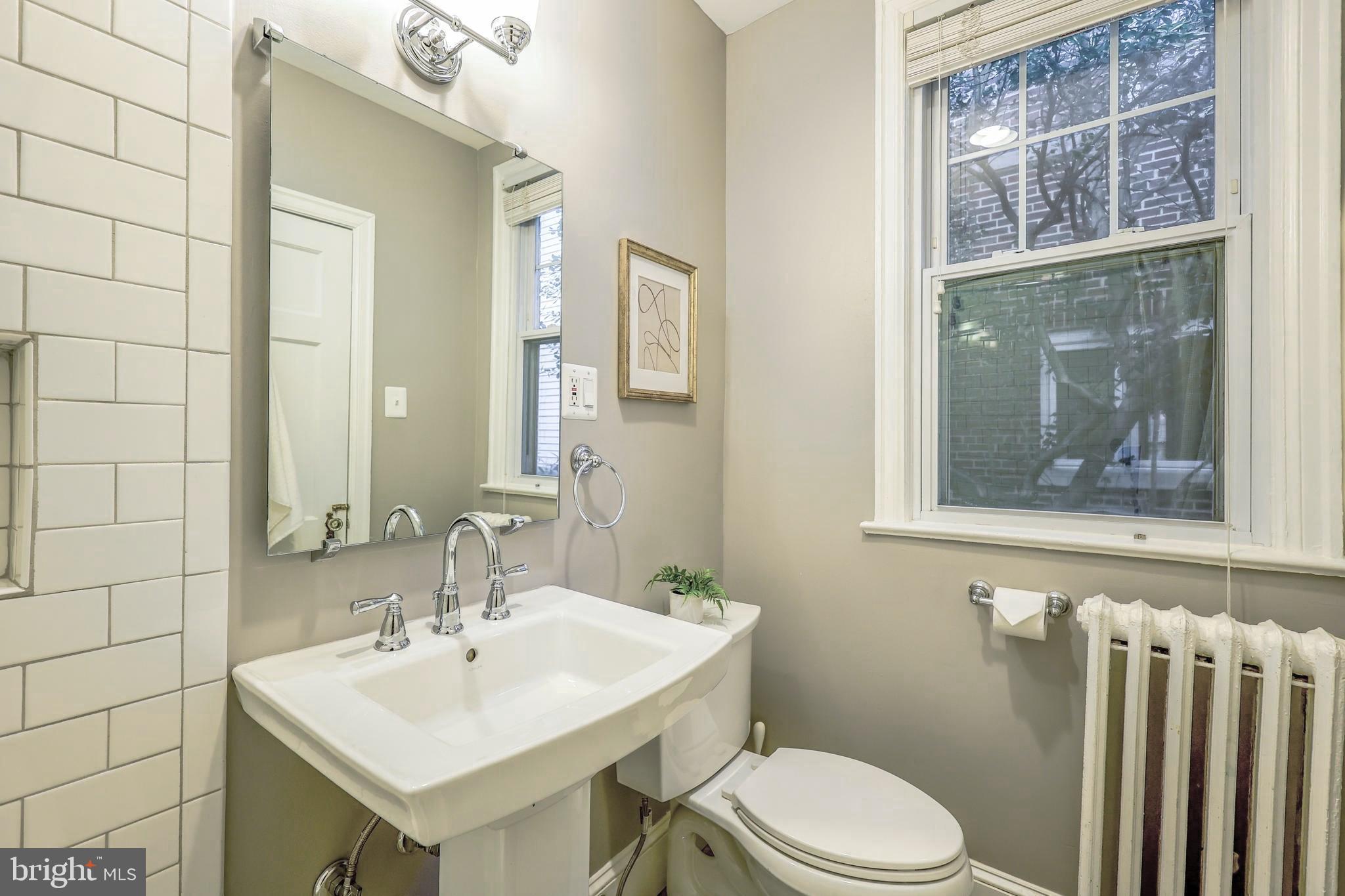 3230 Military Road Northwest Washington, DC 20015 - Photo 25 of 61 a bathroom with a toilet a sink and mirror