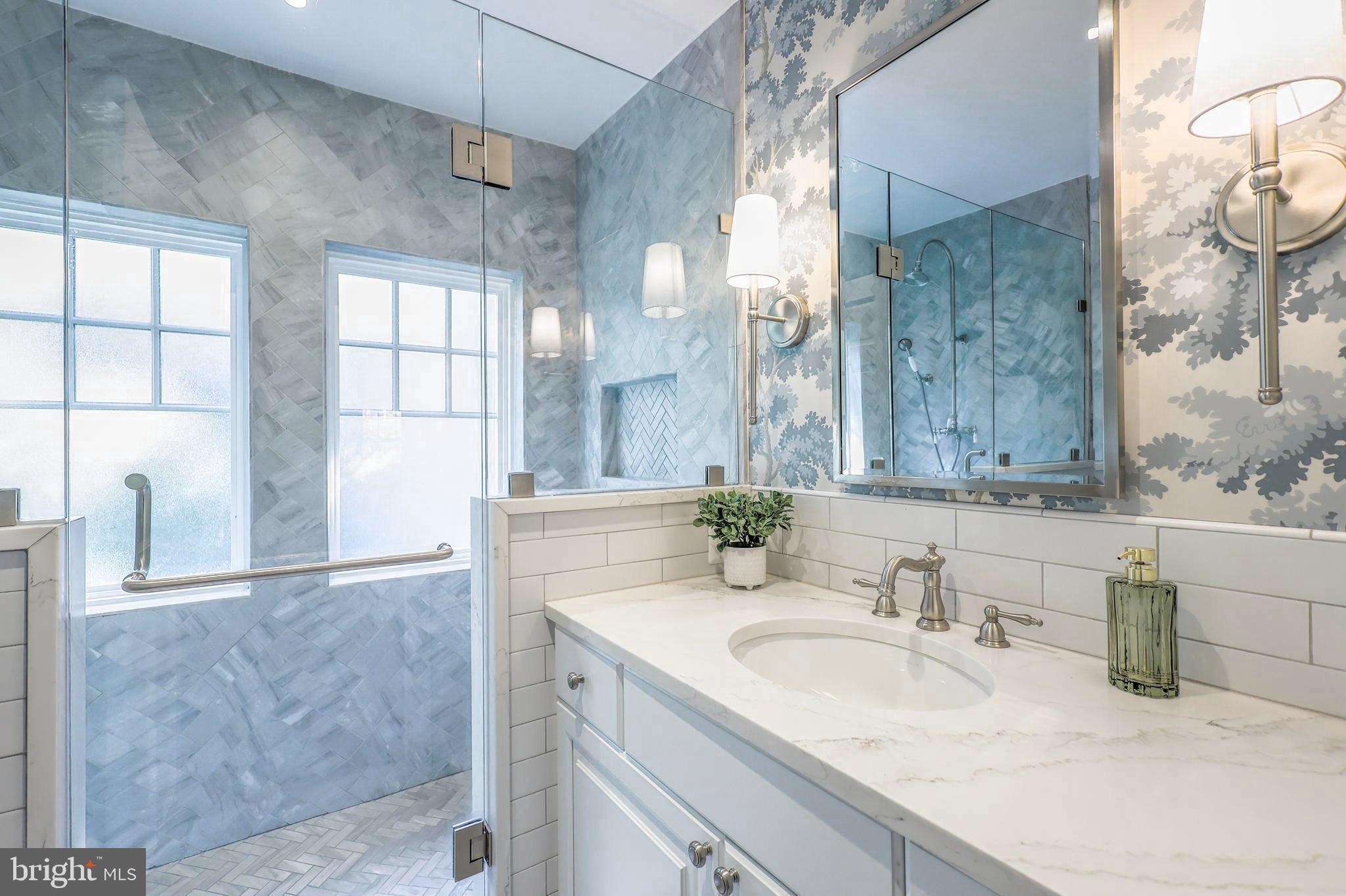 3230 Military Road Northwest Washington, DC 20015 - Photo 30 of 61 a bathroom with a granite countertop sink a mirror and a shower