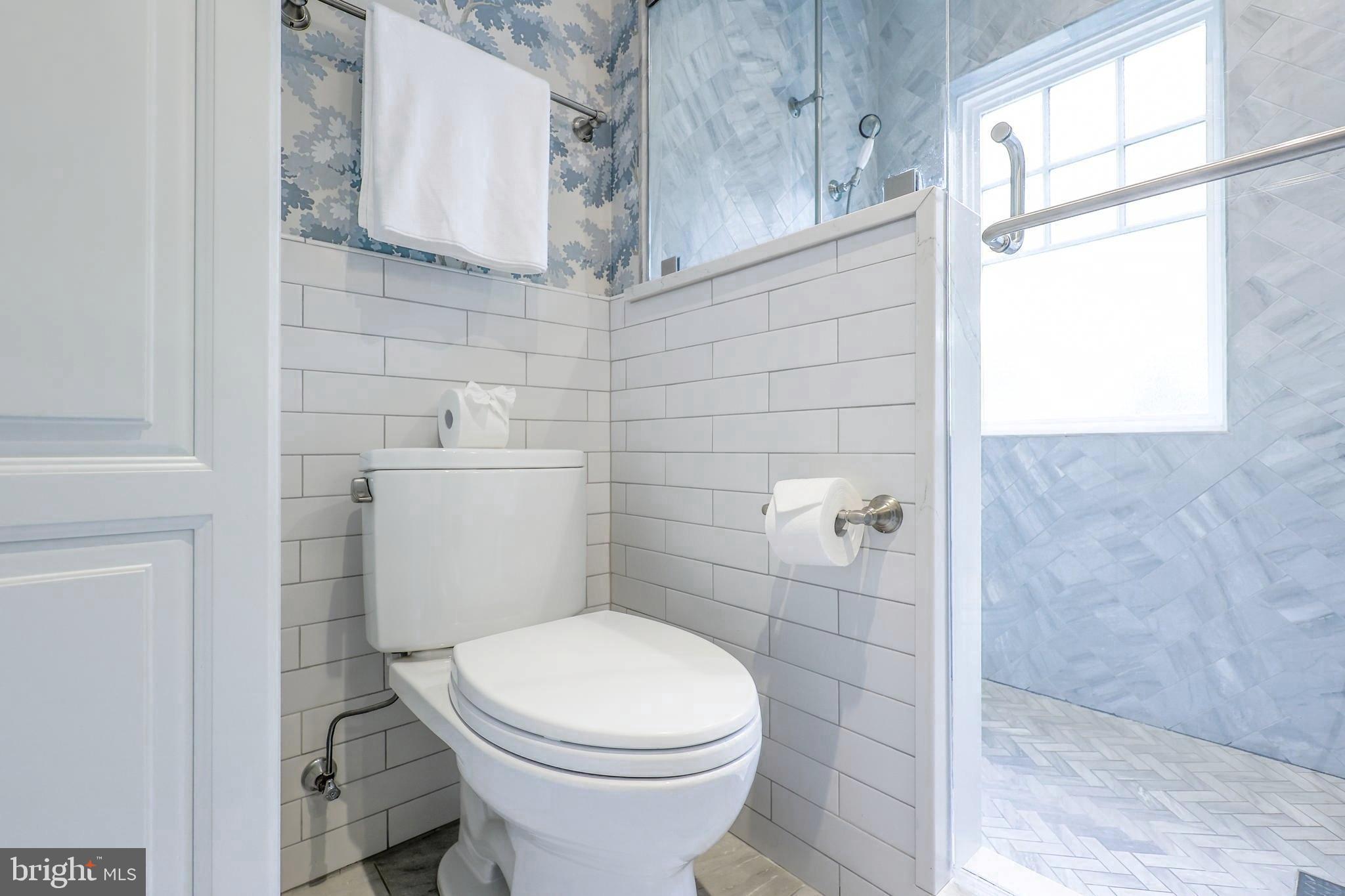 3230 Military Road Northwest Washington, DC 20015 - Photo 31 of 61 a white toilet sitting next to a bathroom sink