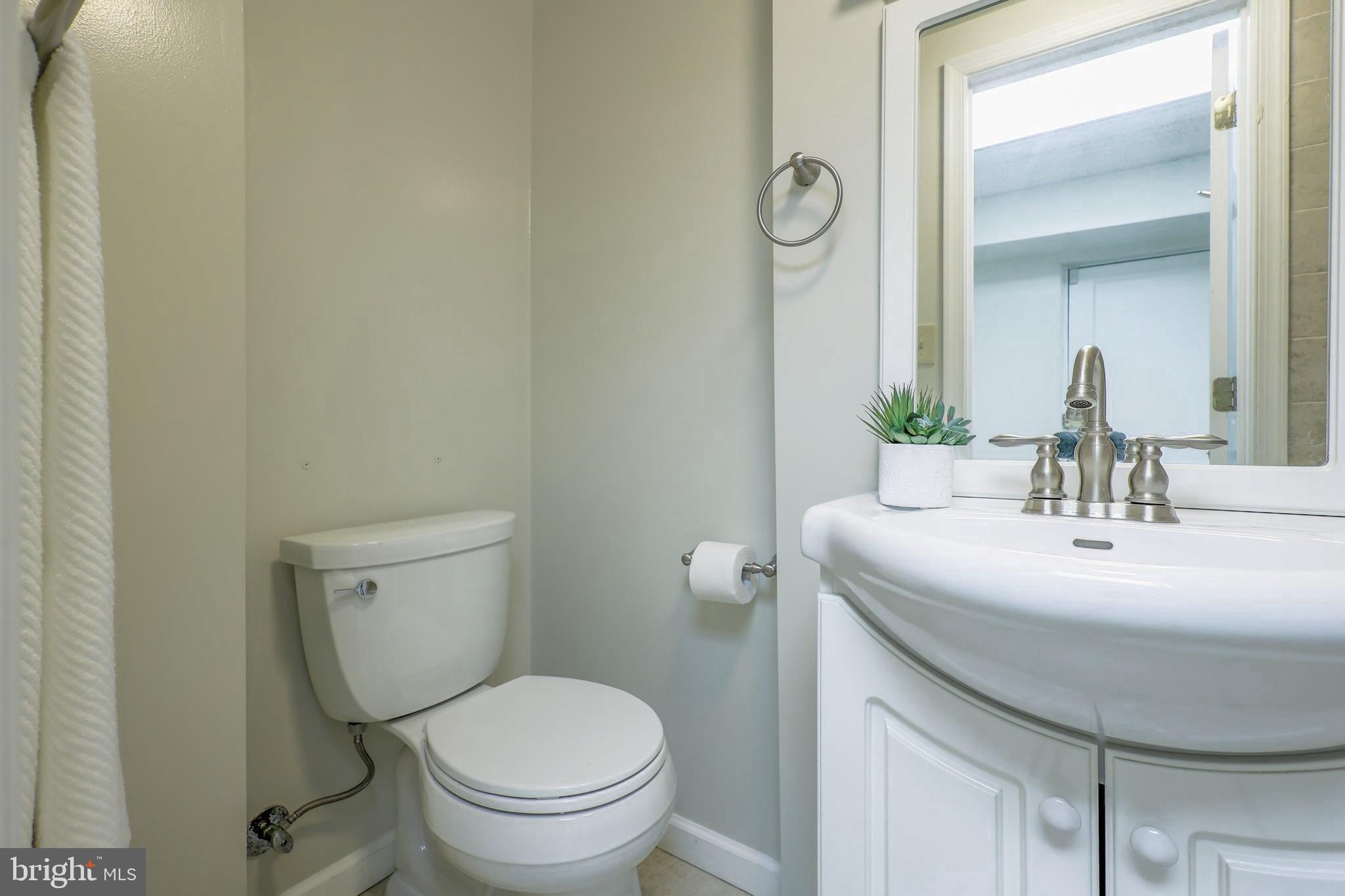 3230 Military Road Northwest Washington, DC 20015 - Photo 47 of 61 a bathroom with a toilet sink and mirror