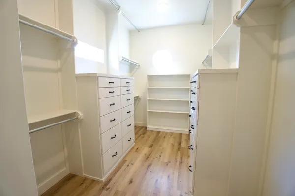 a view of walk in closet with empty racks