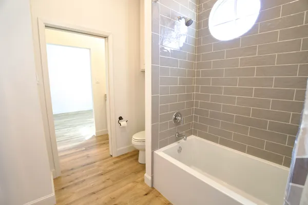 a bathroom with a bathtub and a toilet
