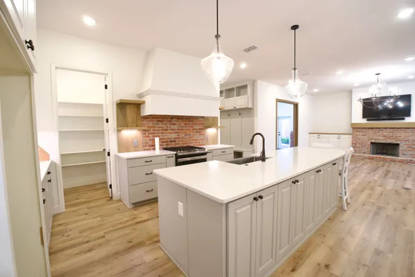 a large kitchen with kitchen island a sink appliances and a floor