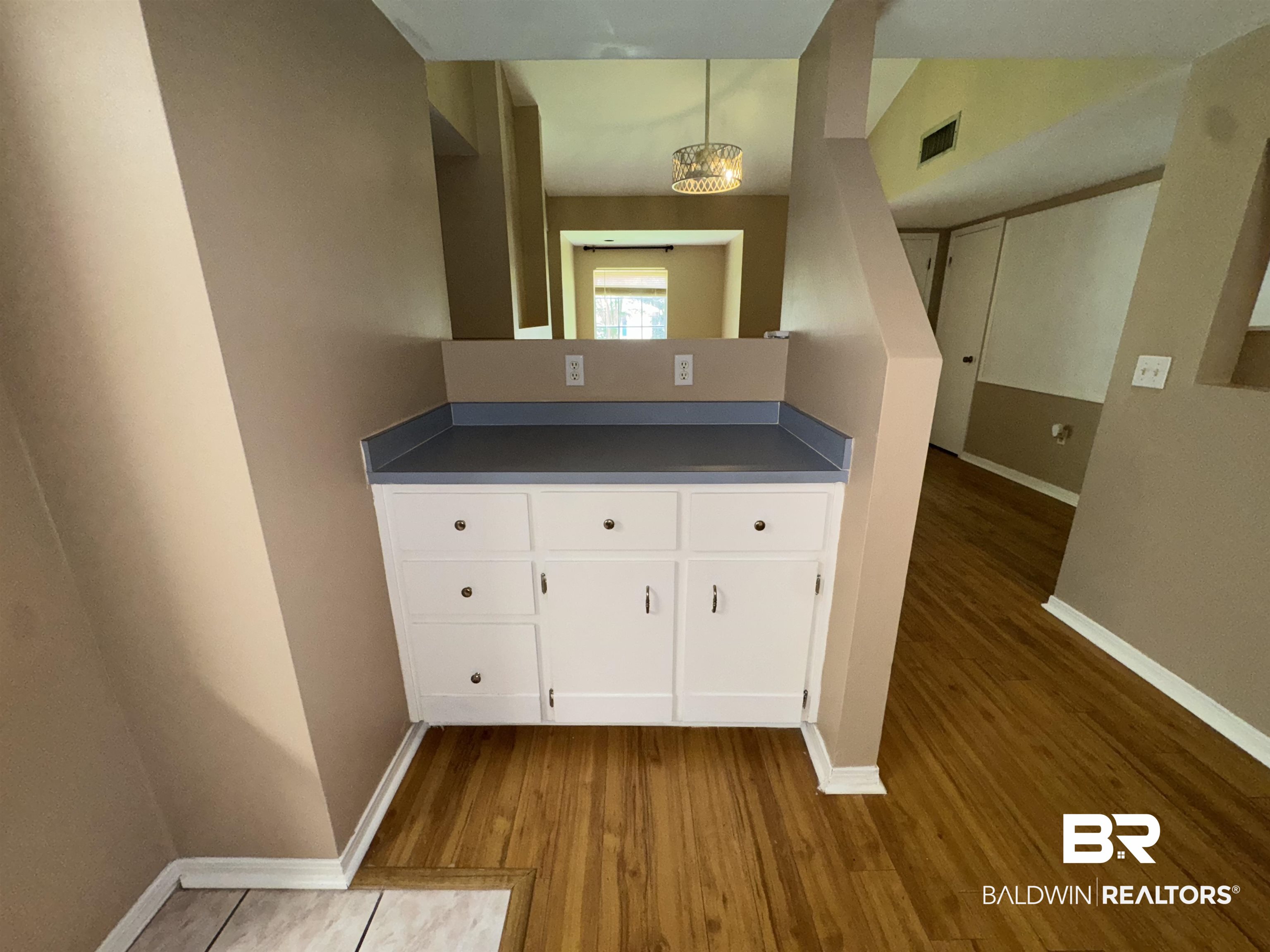 8070 Middle Ring Road Mobile, AL 36619 - Photo 9 of 26 Bar featuring wood finished floors, a chandelier, and decorative light fixtures