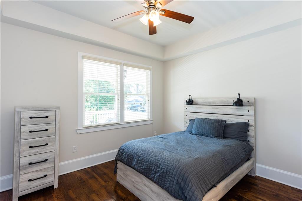 1907 Cambridge Avenue Atlanta, GA 30337 - Photo 14 of 24 a bedroom with a large bed and a chandelier