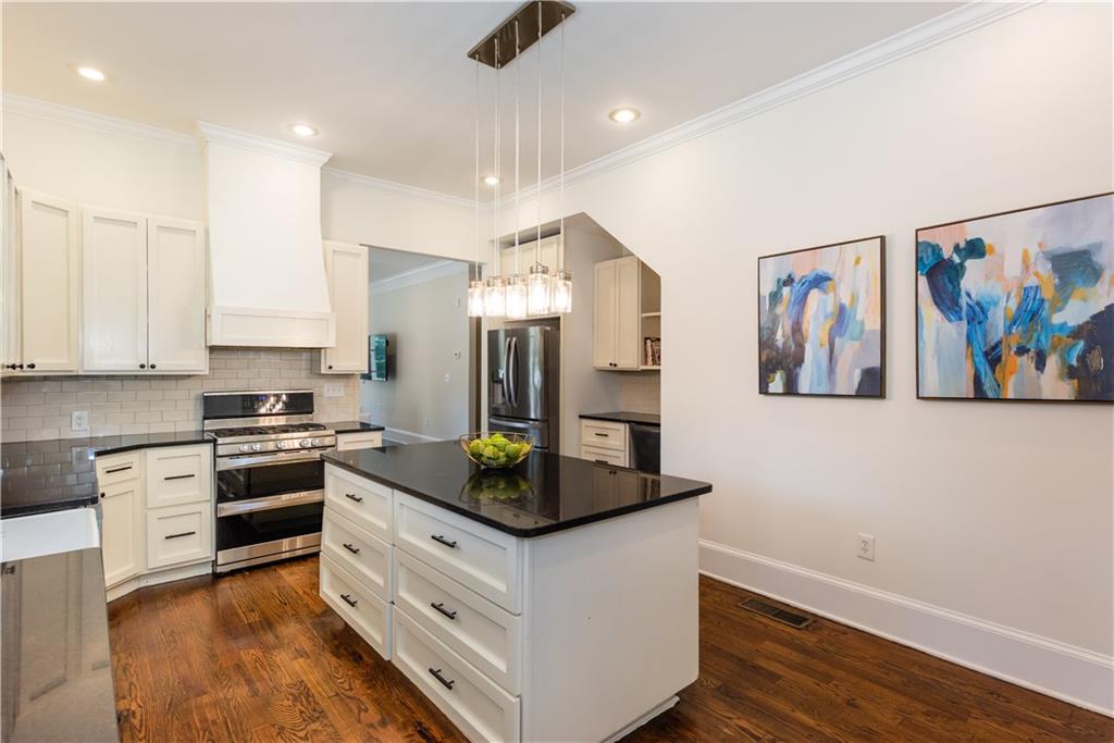 1907 Cambridge Avenue Atlanta, GA 30337 - Photo 3 of 24 a kitchen with stainless steel appliances granite countertop a stove and a sink