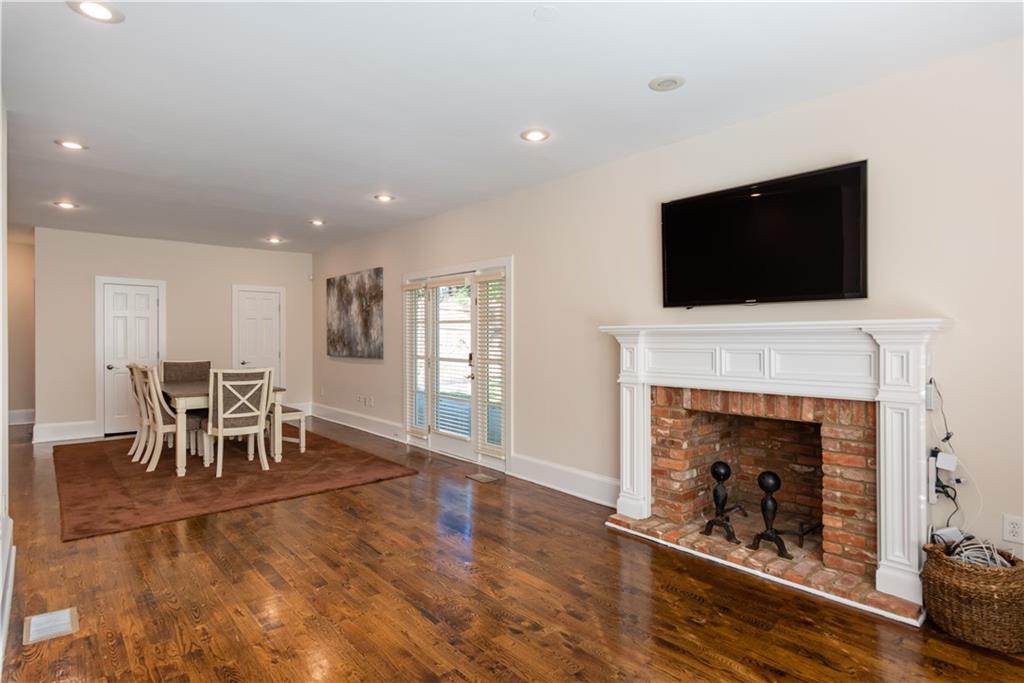 1907 Cambridge Avenue Atlanta, GA 30337 - Photo 6 of 24 a living room with furniture a fireplace and a flat screen tv