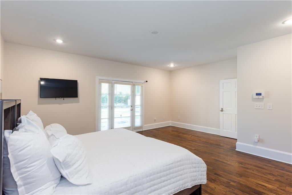 1907 Cambridge Avenue Atlanta, GA 30337 - Photo 9 of 24 a bedroom with a bed and a flat screen tv