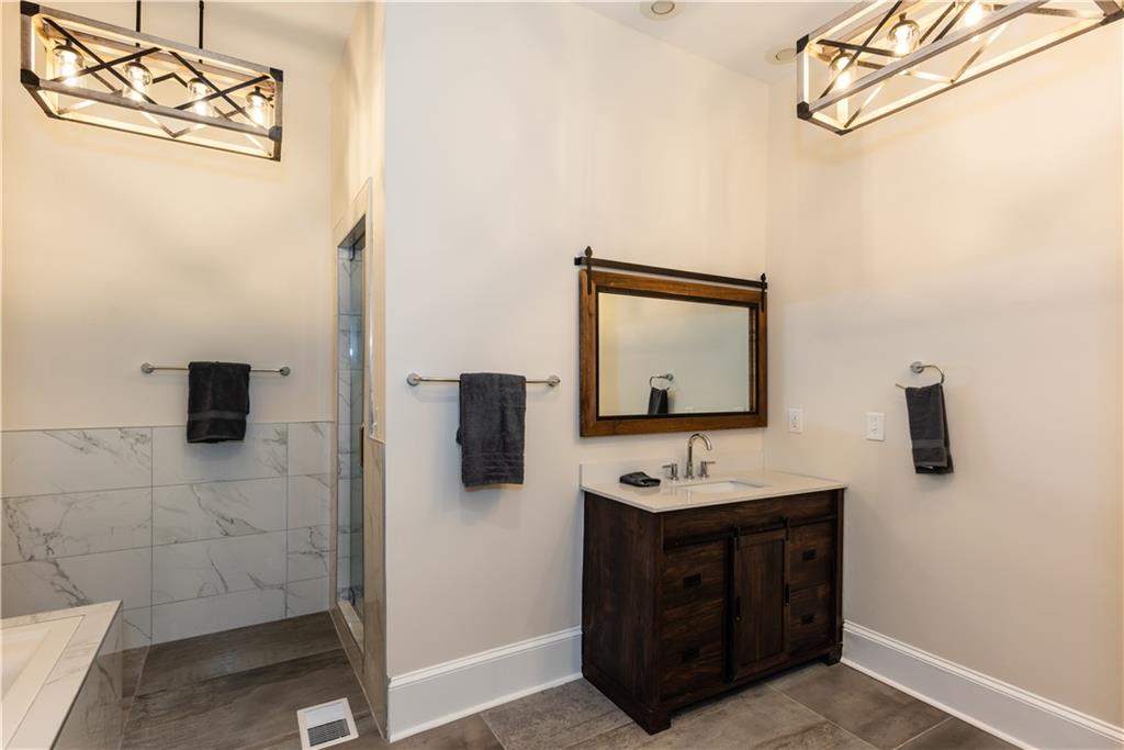 1907 Cambridge Avenue Atlanta, GA 30337 - Photo 10 of 24 a bathroom with a sink and a mirror