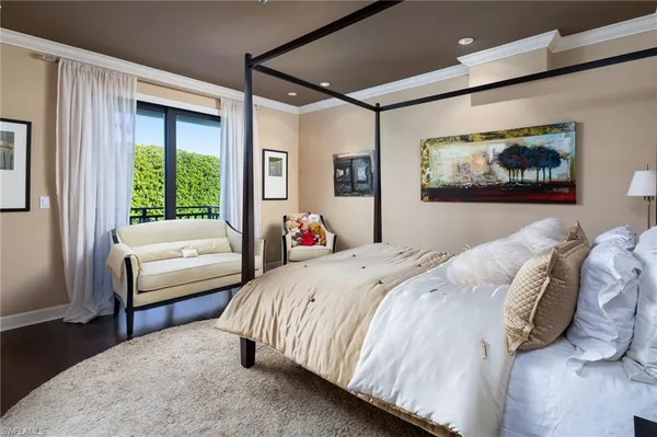 a bedroom with a bed and a painting on the wall