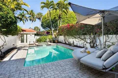 a view of a patio with swimming pool table and chairs