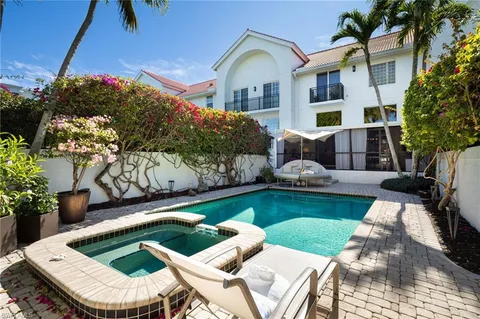 a view of swimming pool with outdoor seating yard and a potted plants