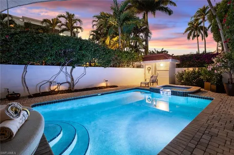 swimming pool view with a seating space
