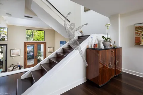 a living room with wooden floor furniture and a window