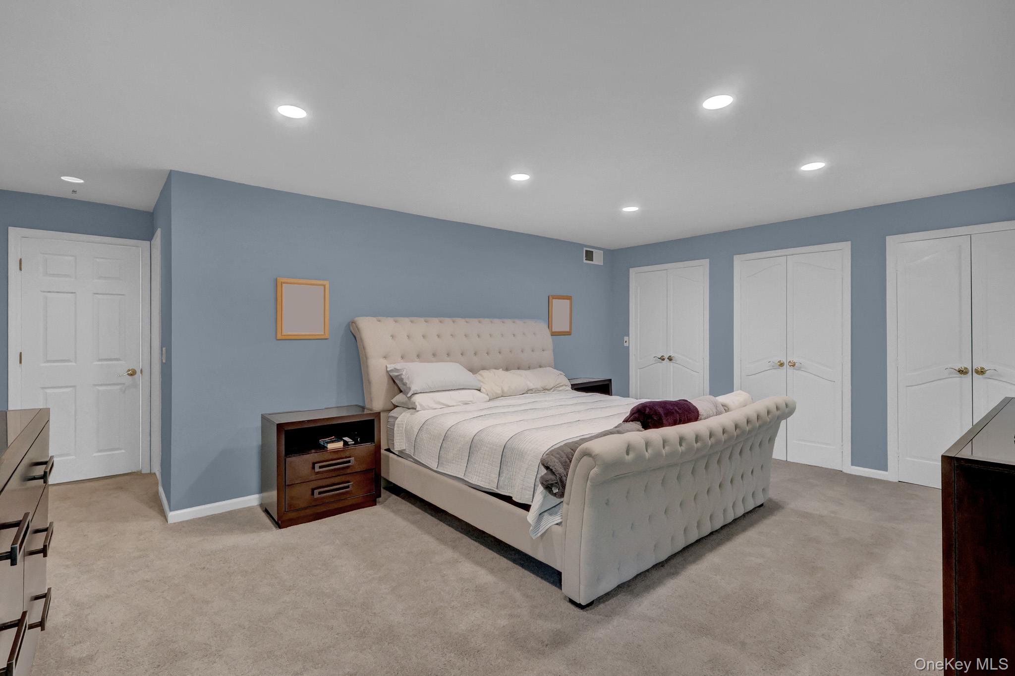 15 Stillwater Road Nissequogue, NY 11780 - Photo 17 of 43 Carpeted room featuring recessed lighting, a neutral wall color, and multiple white bi-fold closet doors