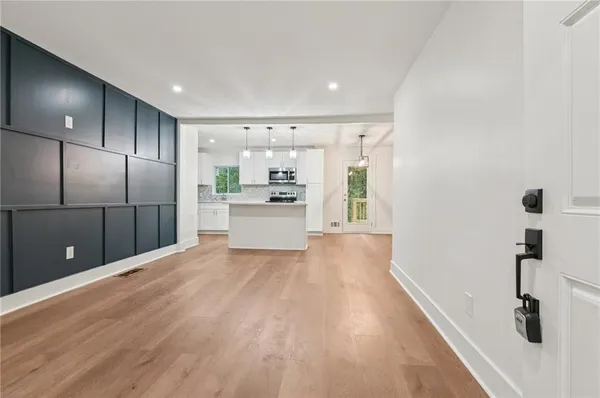 a view of a kitchen with a sink and a refrigerator