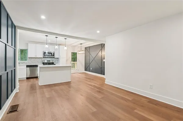 a kitchen with stainless steel appliances a refrigerator and a stove