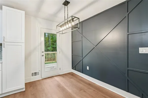 a view of empty room with wooden floor