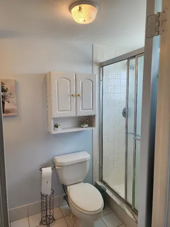 a white toilet sitting next to a bathroom sink