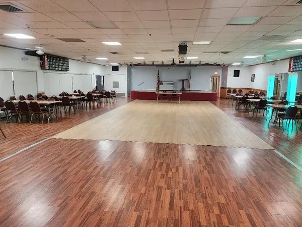 a view of a room with lots of furniture and wooden floor