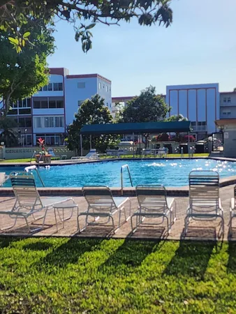 a view of a yard with a table and chairs