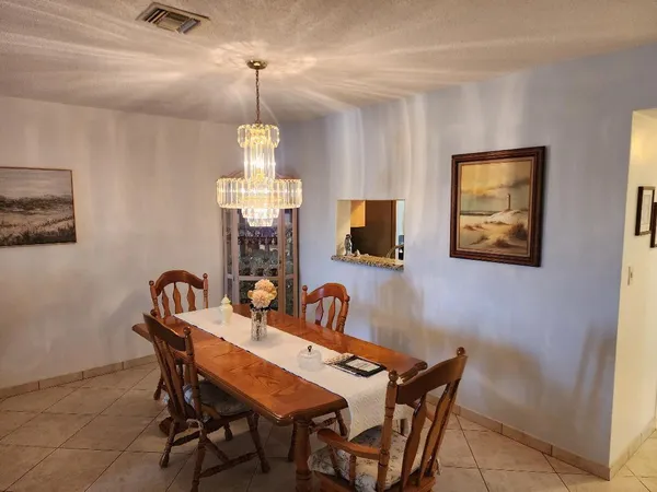 a dining room with furniture and window