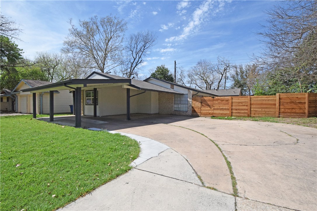 6400 Brookside Drive, Unit B Austin, TX 78723 - Photo 1 of 25 a front view of a house with a garden