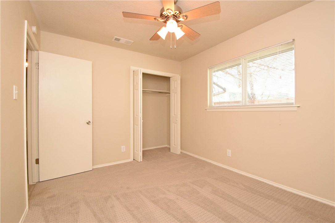 6400 Brookside Drive, Unit B Austin, TX 78723 - Photo 12 of 25 an empty room with windows and fan
