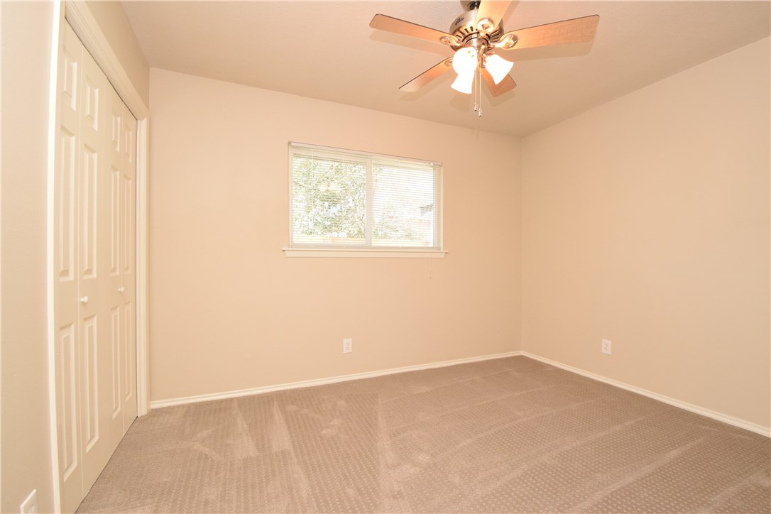 6400 Brookside Drive, Unit B Austin, TX 78723 - Photo 13 of 25 an empty room with a window and a fan