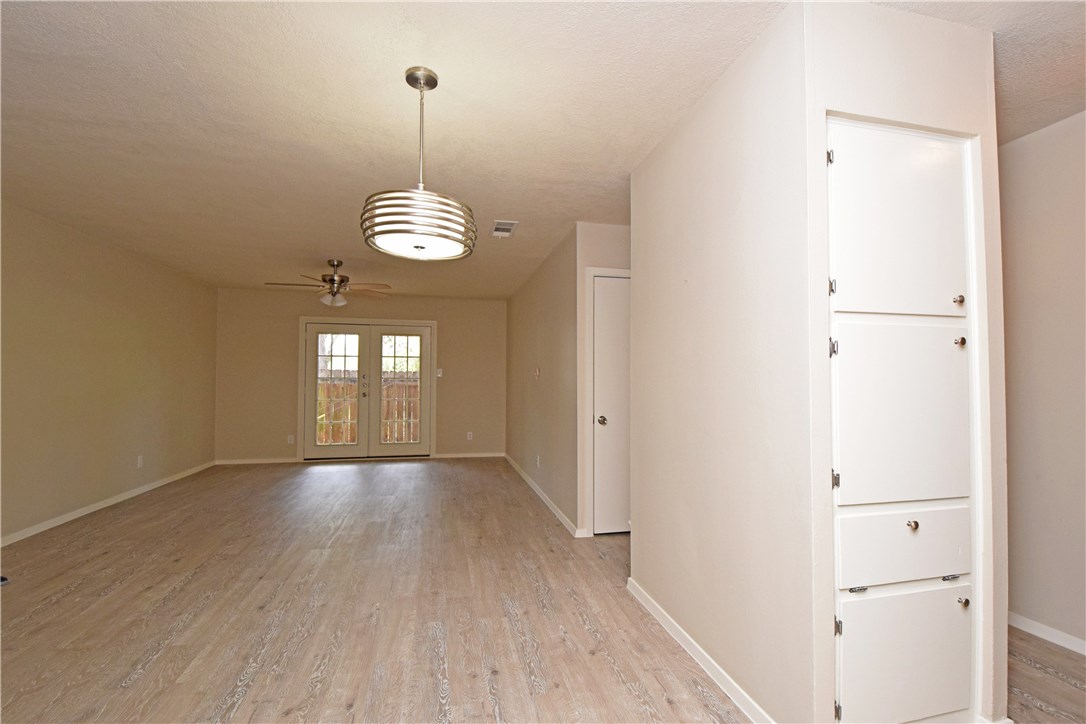 6400 Brookside Drive, Unit B Austin, TX 78723 - Photo 19 of 25 a view of a hallway with wooden floor and window