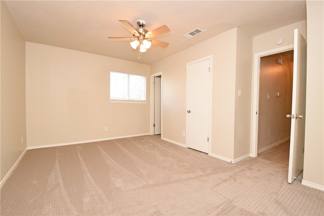 6400 Brookside Drive, Unit B Austin, TX 78723 - Photo 7 of 25 an empty room with chandelier fan and windows