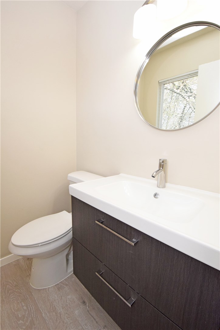 6400 Brookside Drive, Unit B Austin, TX 78723 - Photo 9 of 25 a bathroom with a sink a toilet and mirror