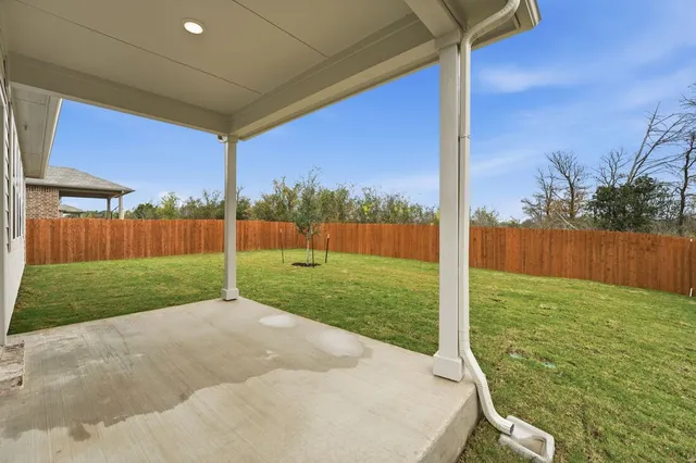 a view of a backyard with grass