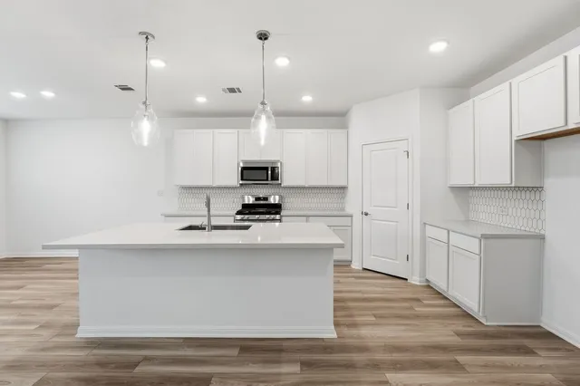 a large kitchen with cabinets