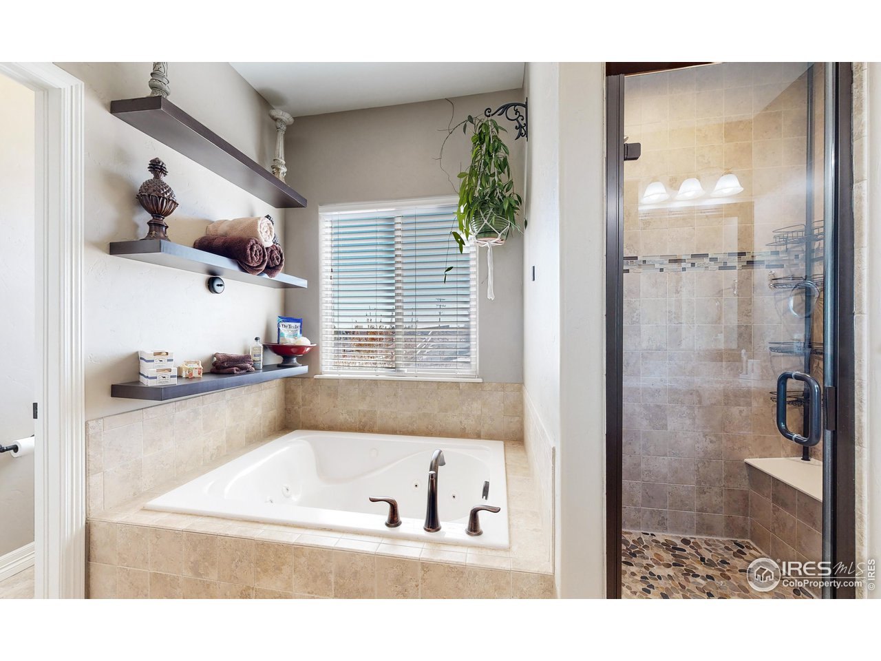 3201 Timeless Circle Berthoud, CO 80513 - Photo 19 of 39 Primary bath has separate walk in shower and jetted tub