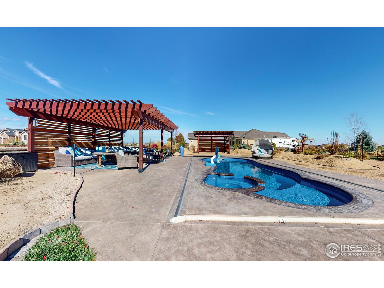 3201 Timeless Circle Berthoud, CO 80513 - Photo 33 of 39 Pool area with two pergolas, one for lounging and a tiki bar