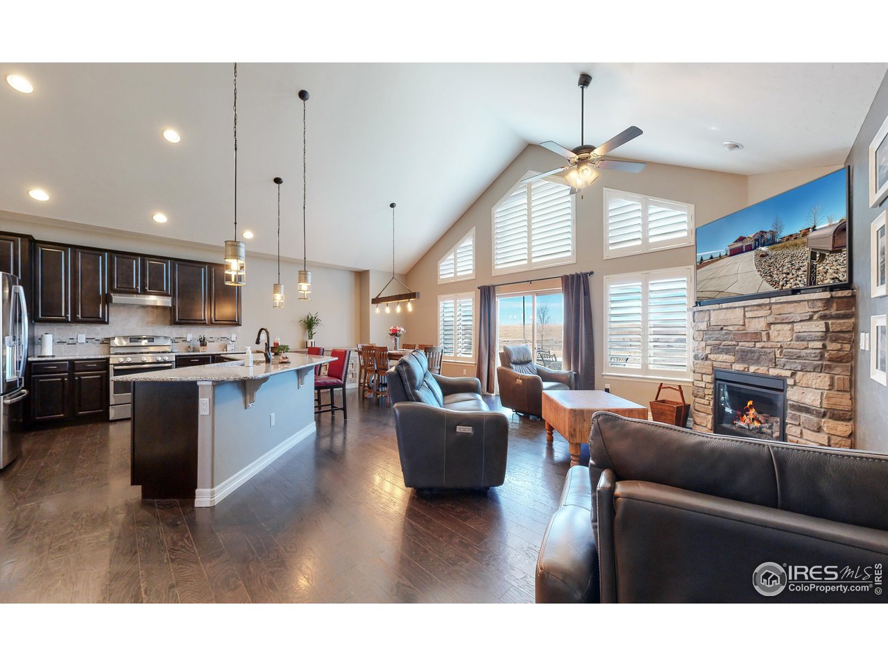 3201 Timeless Circle Berthoud, CO 80513 - Photo 5 of 39 Vaulted ceilings and open concept living with ample natural light from the wall of windows!