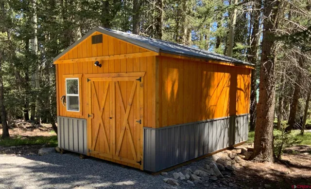 a view of backyard with cabin