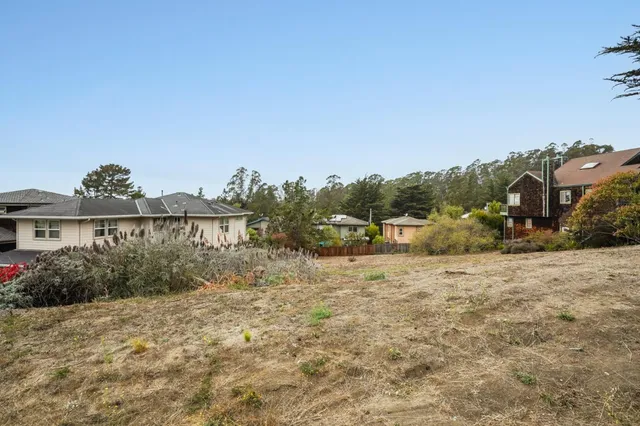 a pathway of a house with a yard